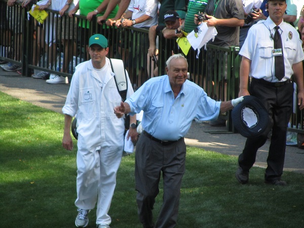 Arnold Palmer, walking on golf course 